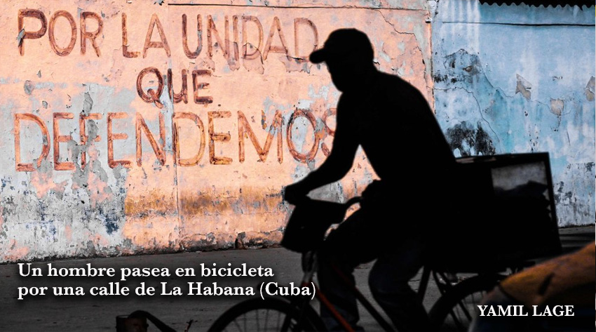 Un hombre en bicicleta por una calle de La Habana (Cuba)