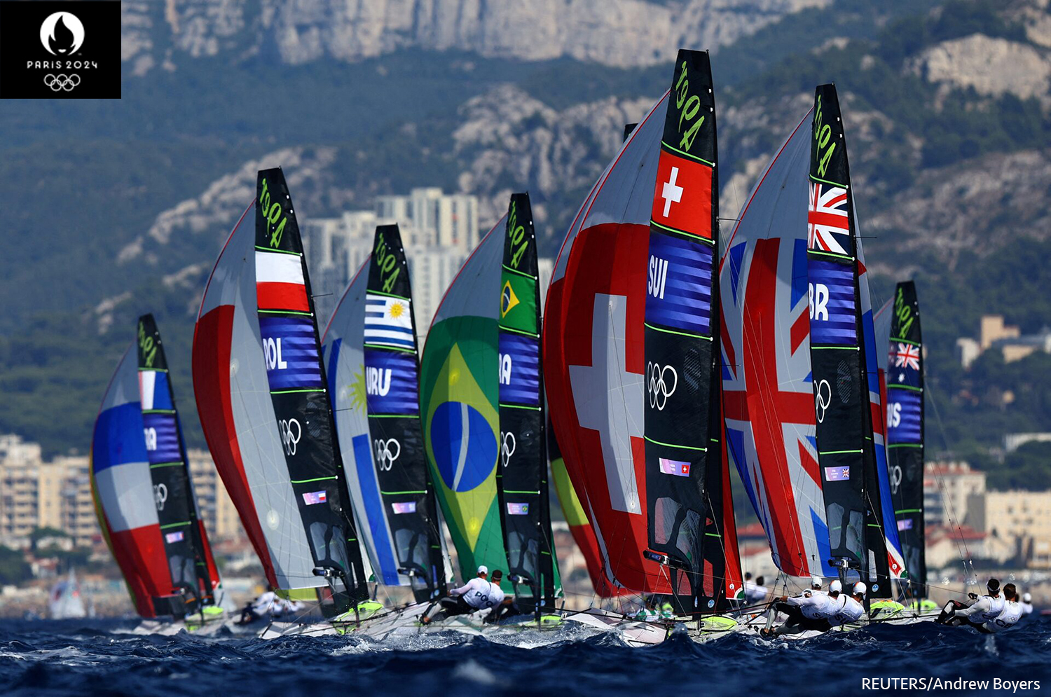 Atletas en acción en la prueba masculina de vela en bote. REUTERS/Andrew Boyers