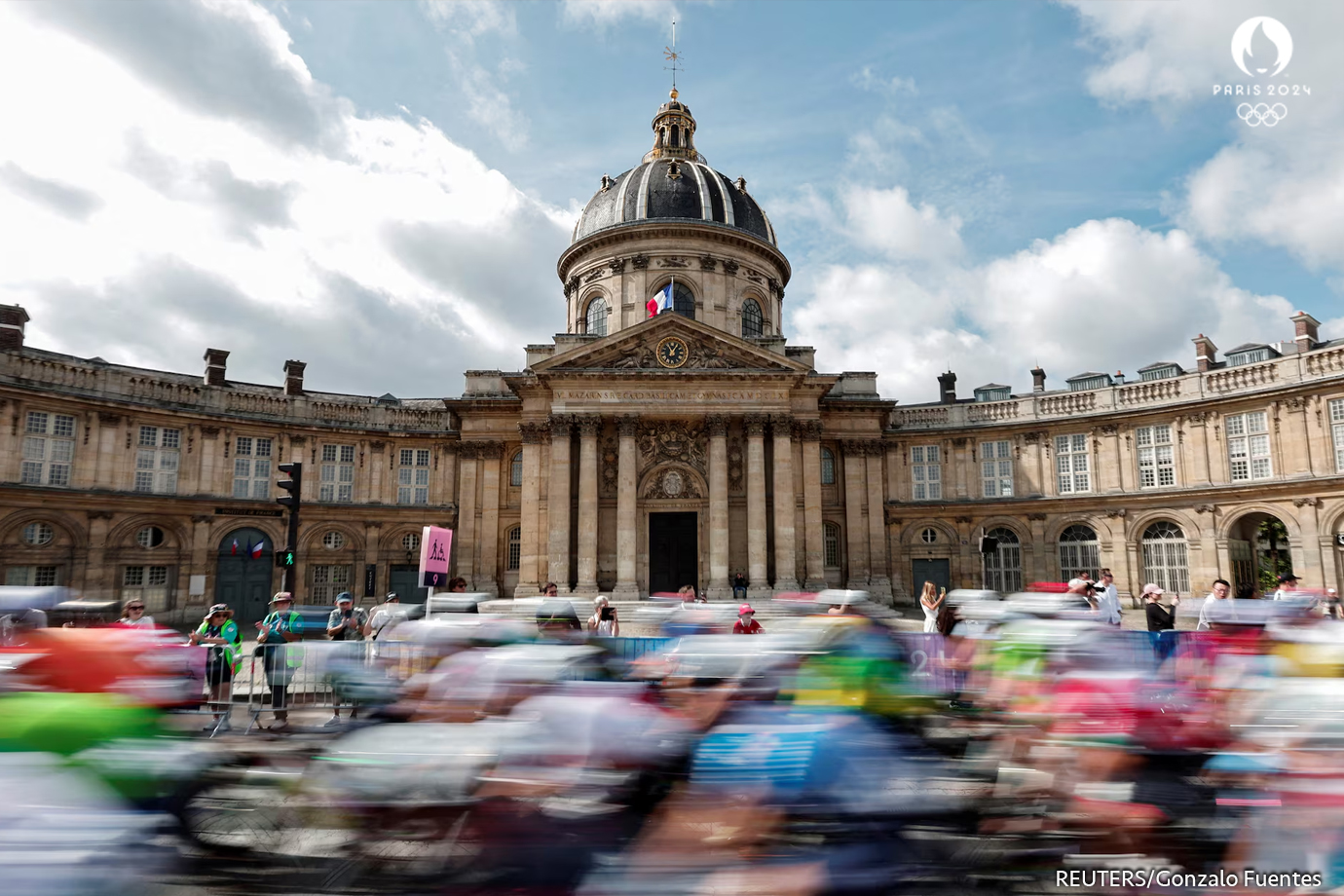 Ciclistas en acción mientras pasan por el Instituto de Francia durante la carrera masculina en ruta.